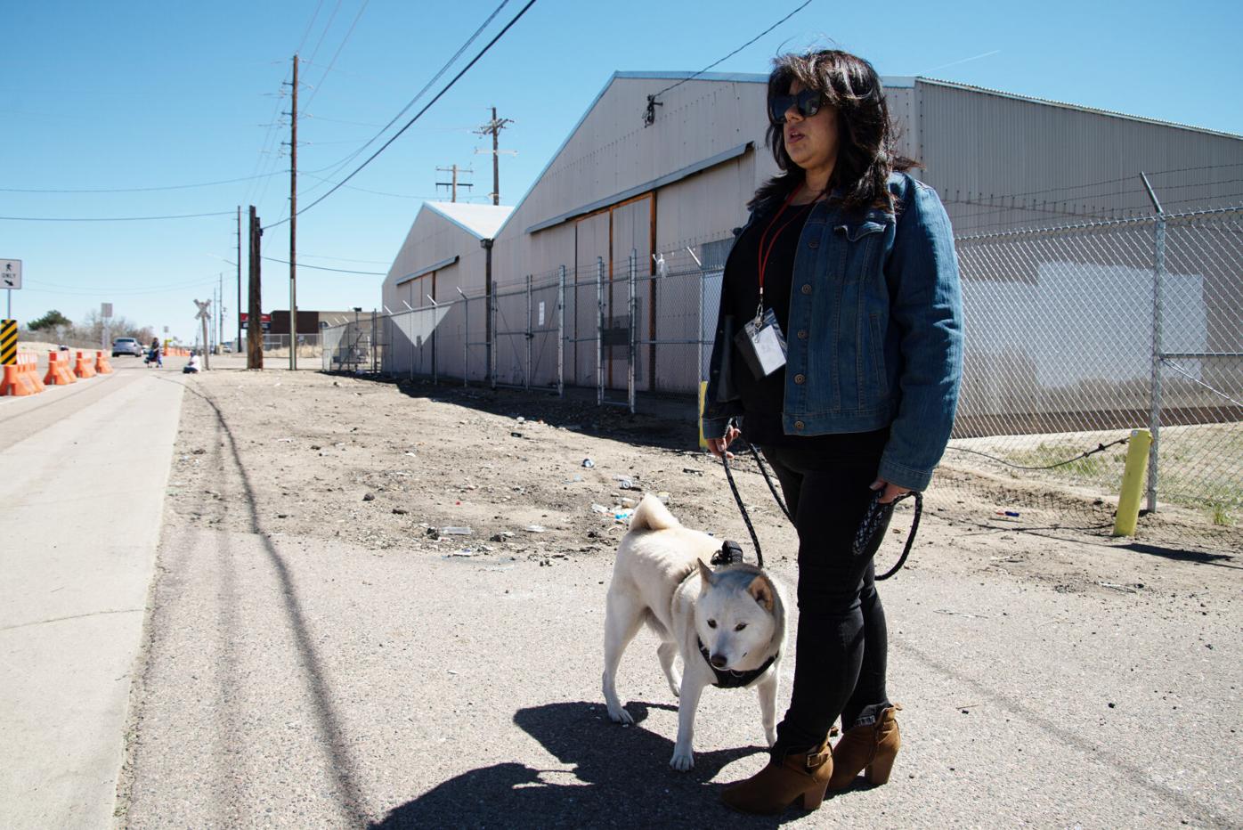 Tanya Chavez walks with her dog Sumo around the site