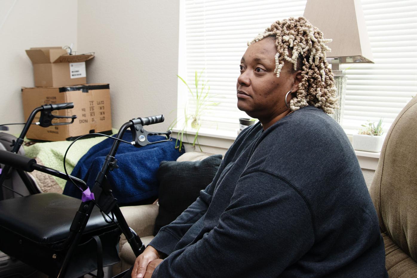 Teri Washington sits next to her walker and amongst her belongings