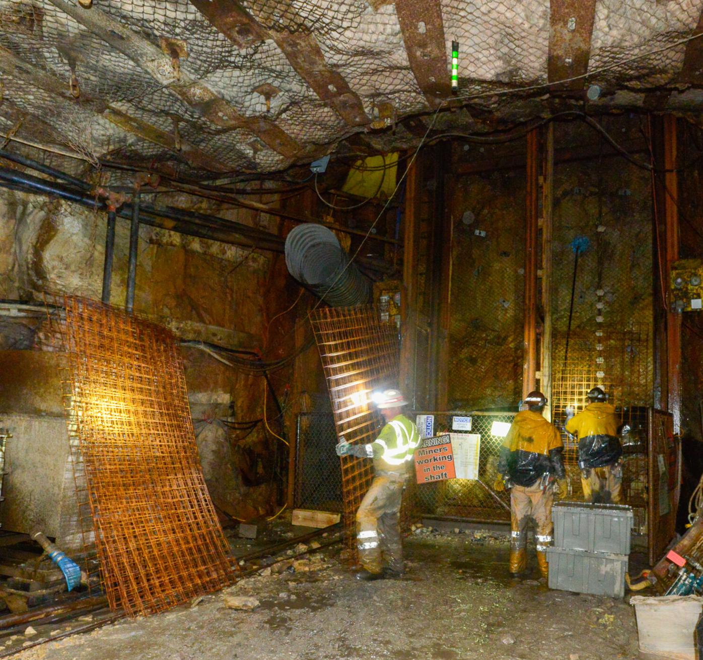 Three miners unload steel grating at the Pinyon Plain Mine.jpg