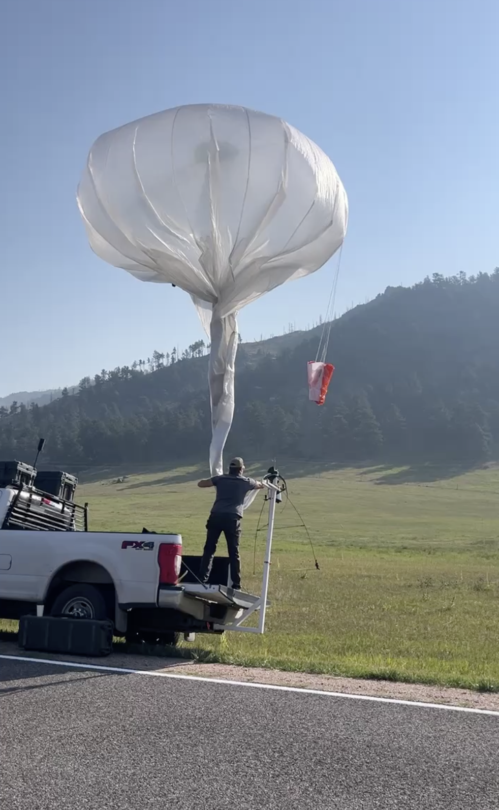 An Urban Sky team member launches a balloon