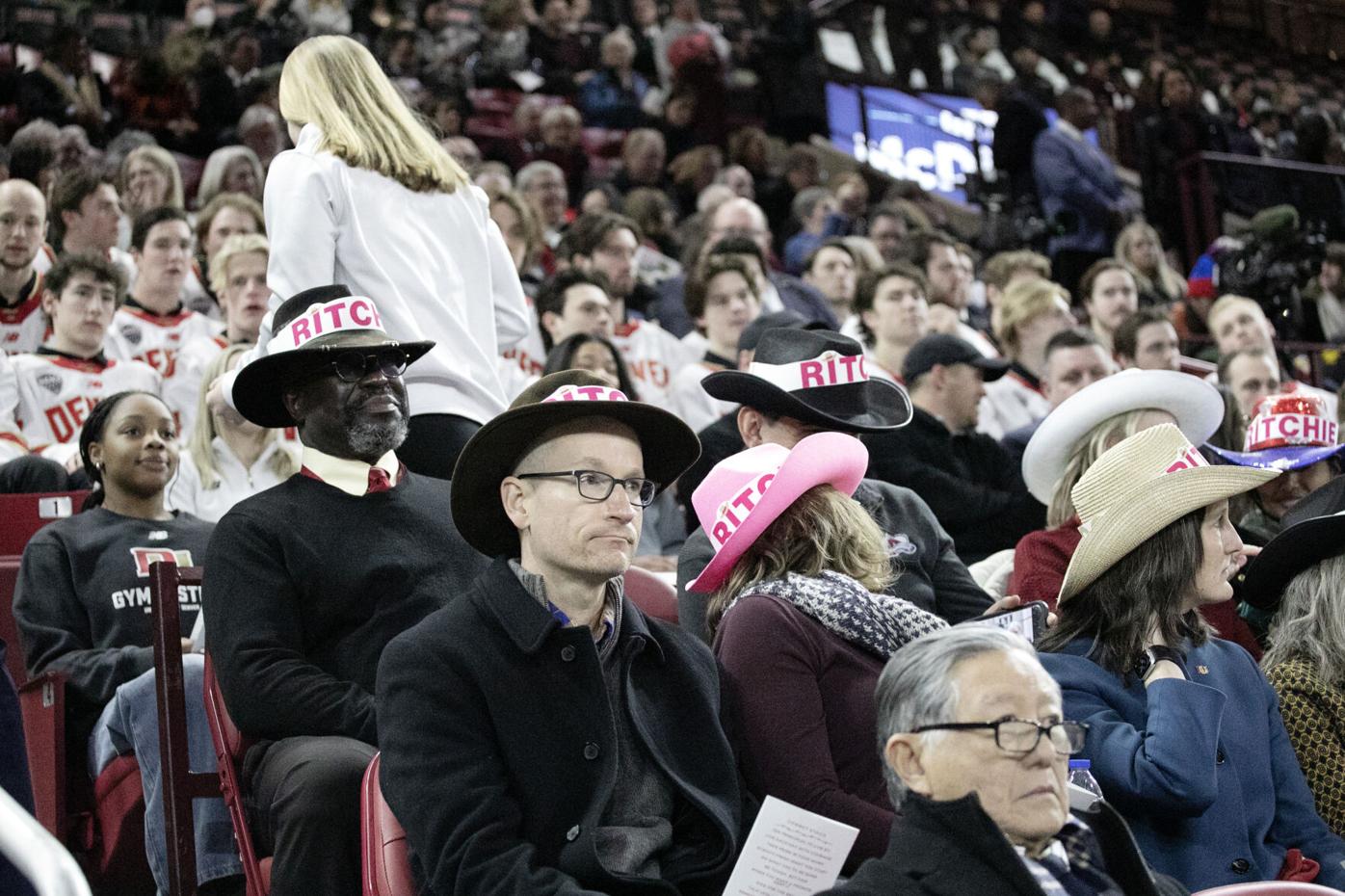 Members of the crowd wear cowboy hats reading 'Ritchie'