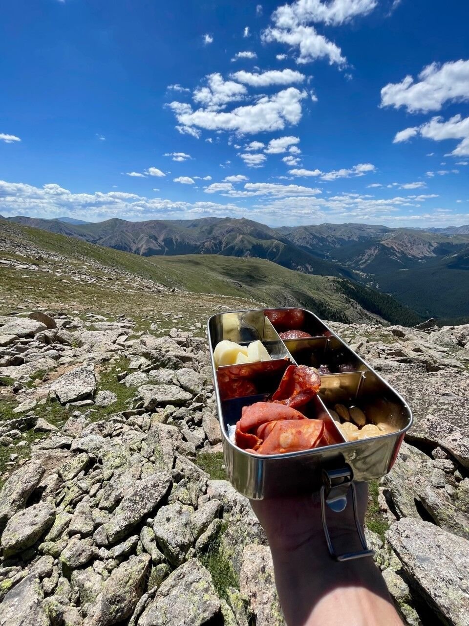A look at the charcuterie-style lunch served mid-trip amid wraparound mountain views. Photo Credit: Spencer McKee.